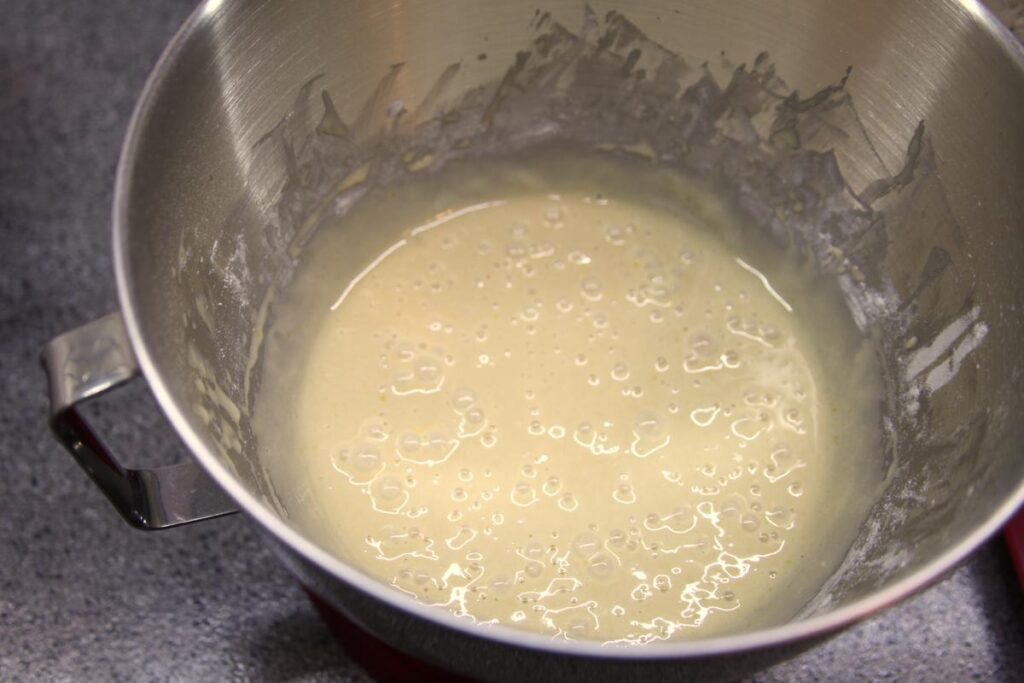 A picture of the batter after the addition of flour. It is thicker than previously pictured and is bubbly.