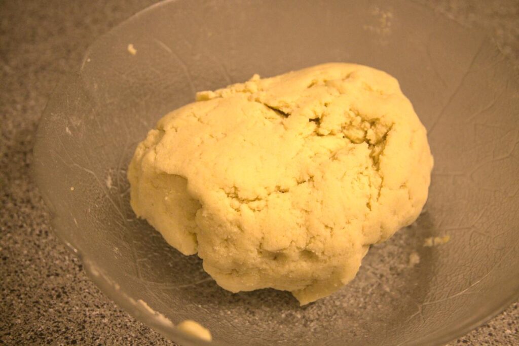 A ball of gnocchi dough. The dough is firm and holds its shape well.