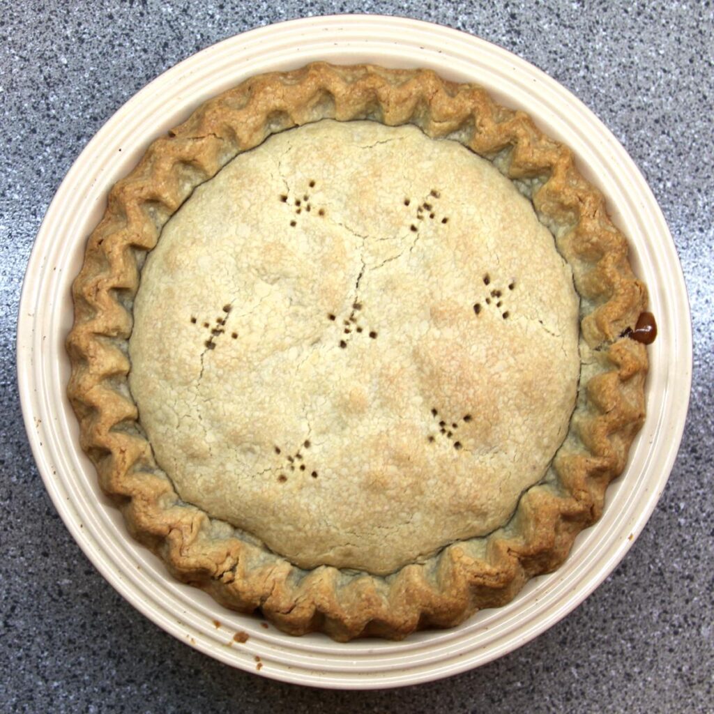A top-down view of a baked pie. The crust is a beautiful golden brown.